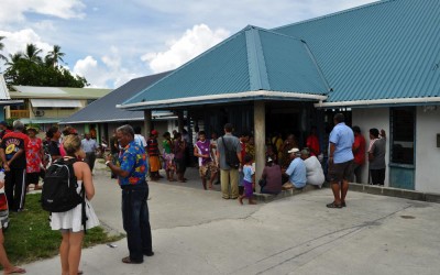The crowd gathers around the terminal building, Funafuti International Airport, Tuvalu, to greet new arrivals on the flight which has just arrived from Suva