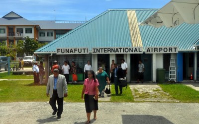 The (then) Tuvaluan Prime Minister walks out to the departing plane at Funafuti International Airport