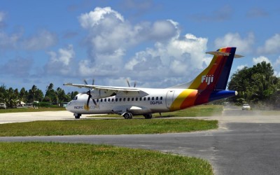 Departing plane taxiing over the road out to the runway, Funafuti Airport